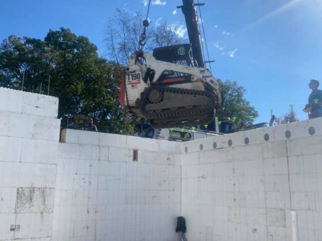 White Excavation Truck Being Moved